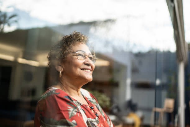 A contented senior woman in her home